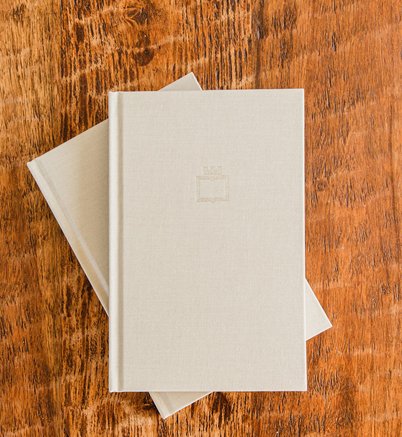 The Overcomers Journal, a linen hardcover Christian journal, on a wood table