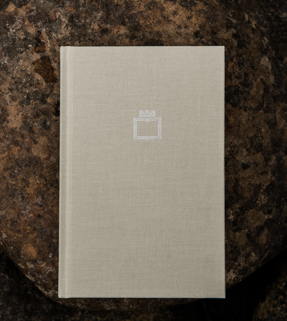 The Overcomers Journal on a dark stone surface